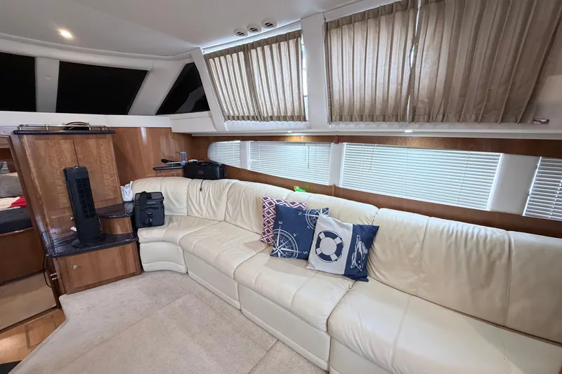 Slide: The Image of Luxurious interior of 2003 Carver 396 Motor Yacht with cream leather seating and nautical decor. - 16