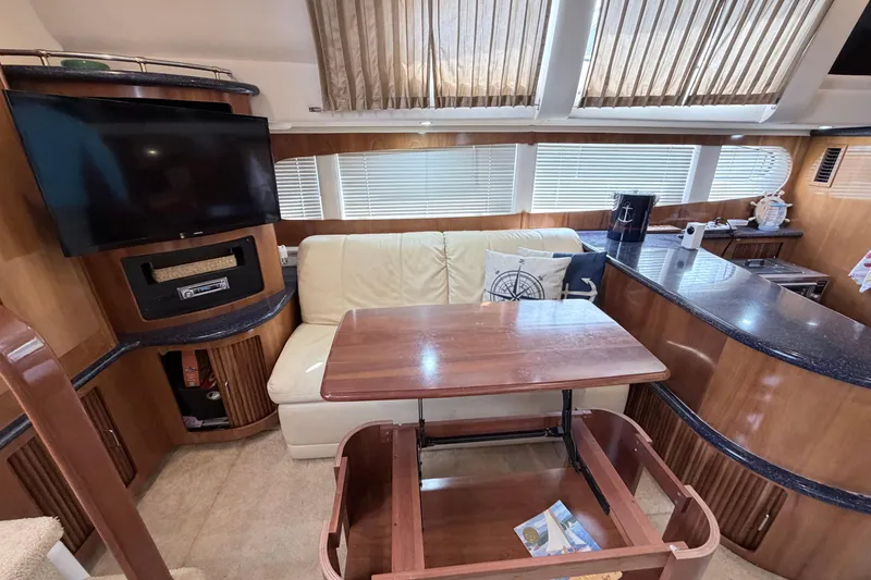 Slide: The Image of Interior of 2003 Carver 396 Motor Yacht with sofa, table, and TV in cozy setting. - 19