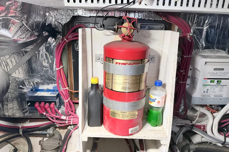 Slide: The Image of Engine room of 2003 Carver 396 Motor Yacht with fire extinguisher and wiring. - 43