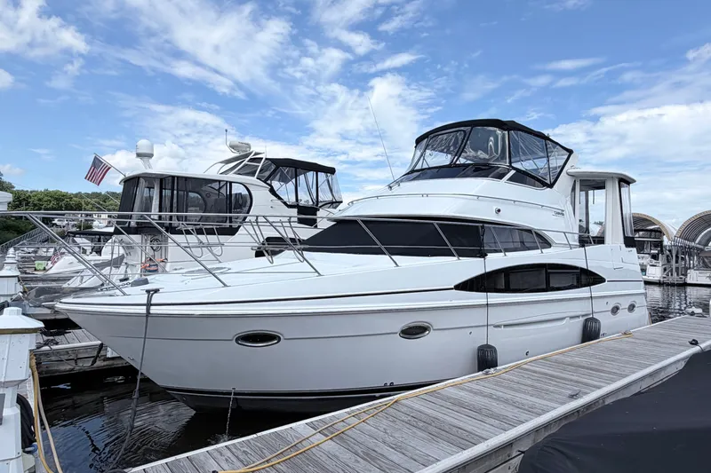 The Image of 2003 Carver 396 Motor Yacht docked at marina under blue sky. - 0