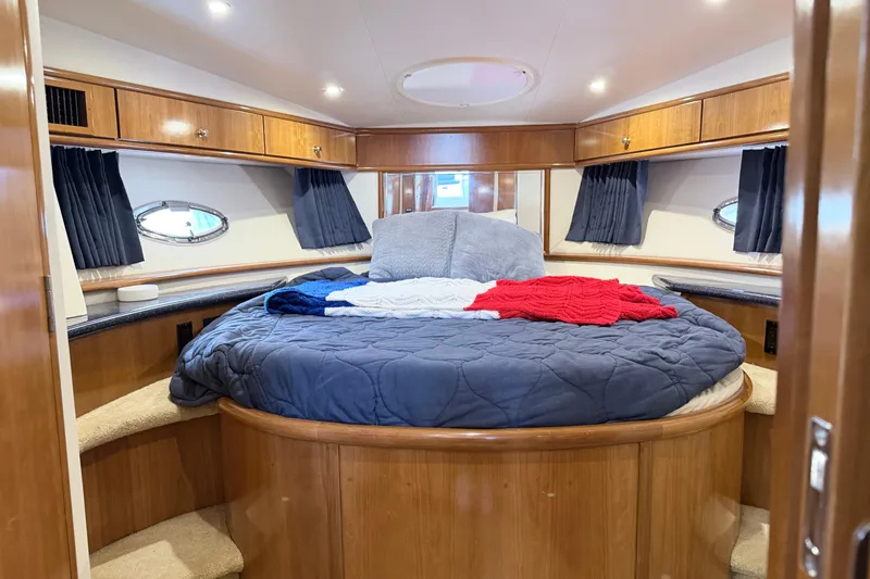 Slide: The Image of Luxurious bedroom interior of 2003 Carver 396 Motor Yacht with cozy bedding and wood accents. - 22