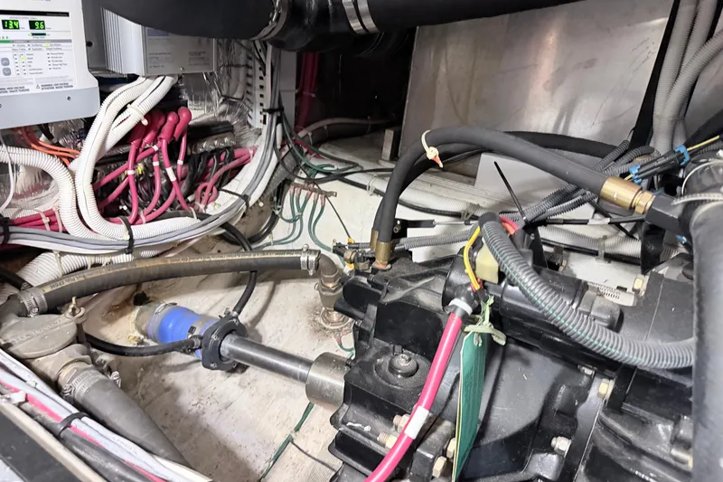 Slide: The Image of Engine room of 2003 Carver 396 Motor Yacht with visible wiring and hoses. - 44