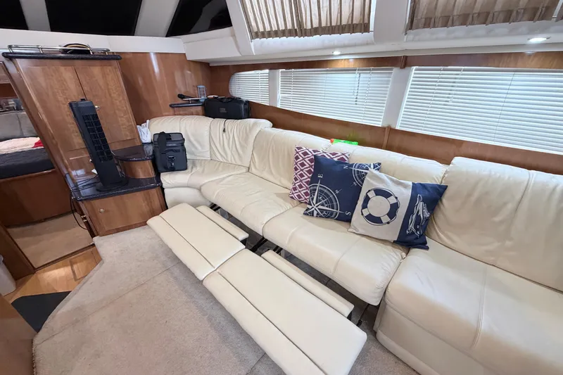 Slide: The Image of Luxurious interior of 2003 Carver 396 Motor Yacht with plush seating and nautical-themed pillows. - 17