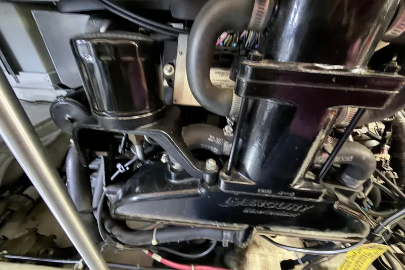 Slide: The Image of Engine compartment of a 2003 Carver 396 Motor Yacht, featuring Mercury components. - 49