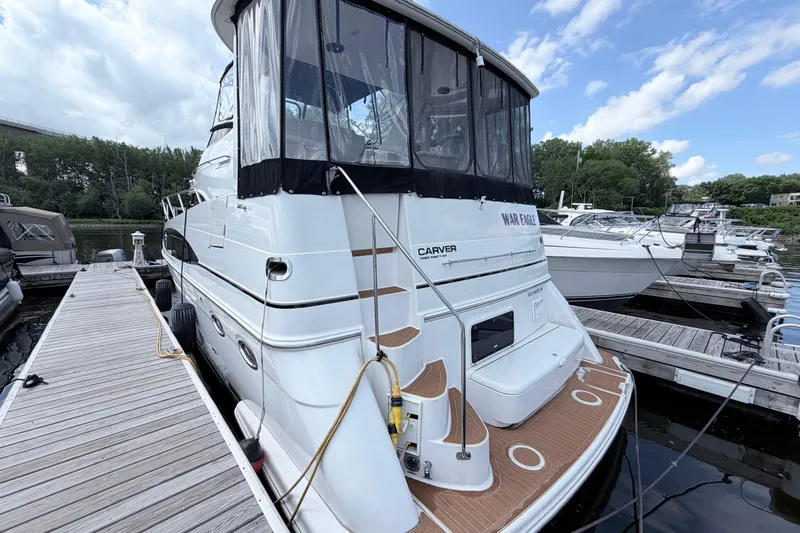 Slide: The Image of 2003 Carver 396 Motor Yacht docked at marina under cloudy sky. - 3
