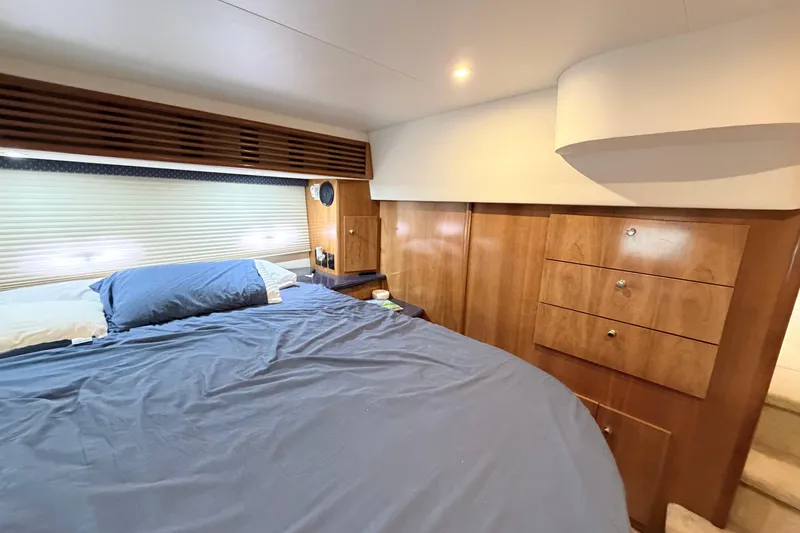 Slide: The Image of Luxurious bedroom interior of 2003 Carver 396 Motor Yacht with wooden cabinetry and cozy bedding. - 35
