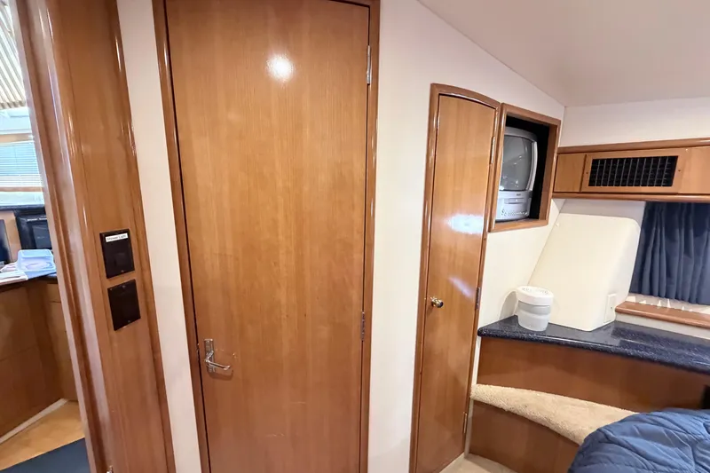 Slide: The Image of Interior of 2003 Carver 396 Motor Yacht with wood paneling and built-in TV. - 23
