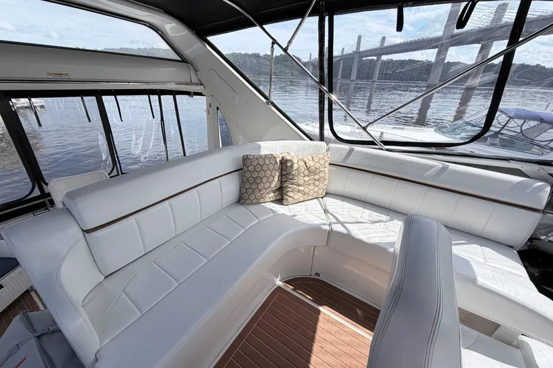 Slide: The Image of Luxurious interior of 2003 Carver 396 Motor Yacht with white seating and scenic water view. - 6