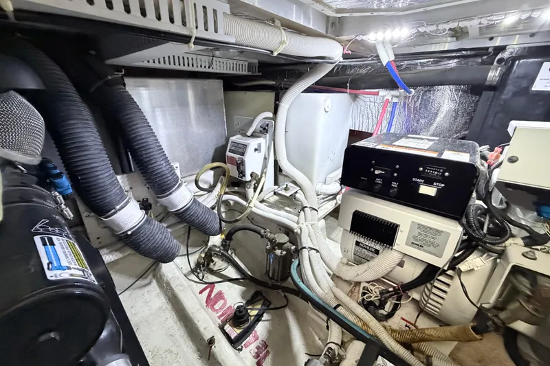 Slide: The Image of Engine room of a 2003 Carver 396 Motor Yacht, showcasing mechanical components and wiring. - 46