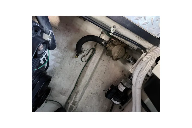 Slide: The Image of Engine compartment of a 2003 Carver 396 Motor Yacht, showing hoses and mechanical components. - 51