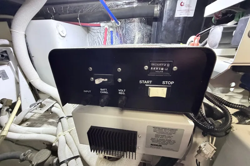 Slide: The Image of Control panel of a 2003 Carver 396 Motor Yacht engine room, featuring start and stop buttons. - 54