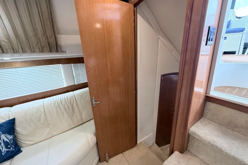 Slide: The Image of Interior of 2003 Carver 396 Motor Yacht with white sofa and wooden door. - 29