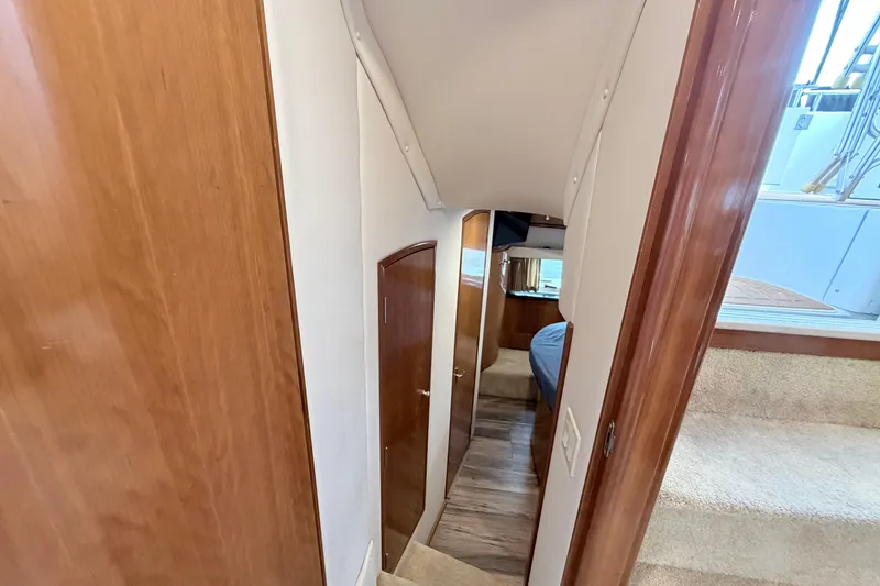 Slide: The Image of Interior hallway of 2003 Carver 396 Motor Yacht, featuring wood paneling and carpeted stairs. - 30