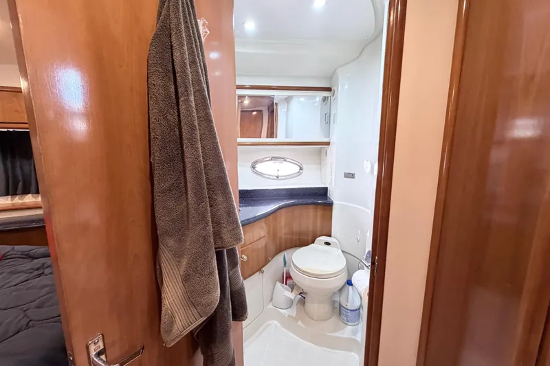 Slide: The Image of Bathroom interior of 2003 Carver 396 Motor Yacht, featuring wood cabinetry and modern fixtures. - 27