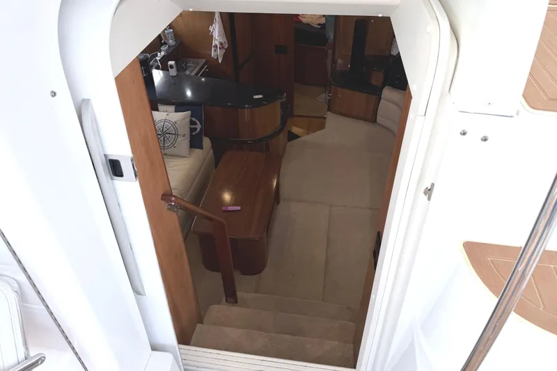 Slide: The Image of Interior view of 2003 Carver 396 Motor Yacht, featuring cozy seating and wooden accents. - 14