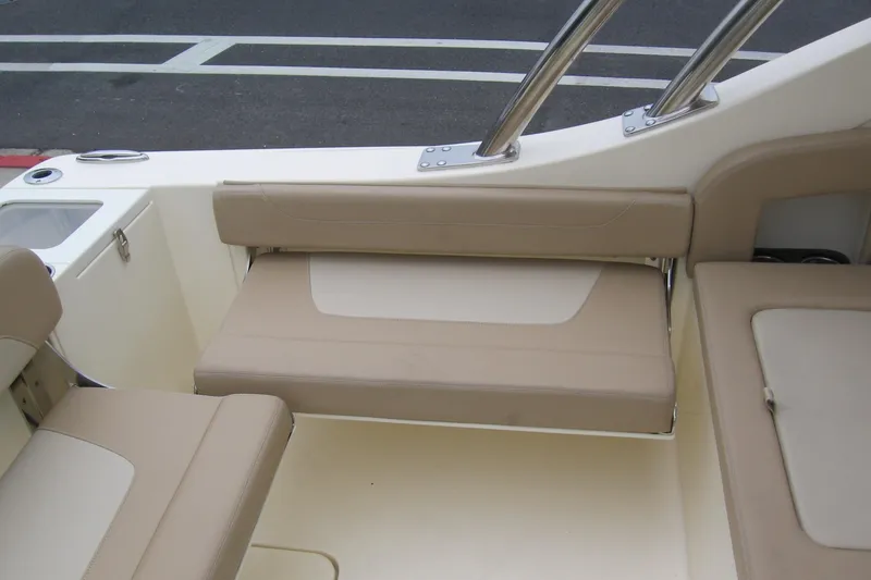 Slide: The Image of 2024 Scout 255 Dorado boat interior with beige seating and stainless steel accents. - 7