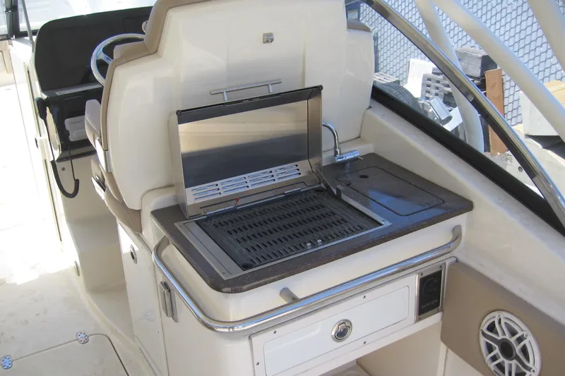 Slide: The Image of 2024 Scout 255 Dorado boat interior with built-in grill and sink. - 4