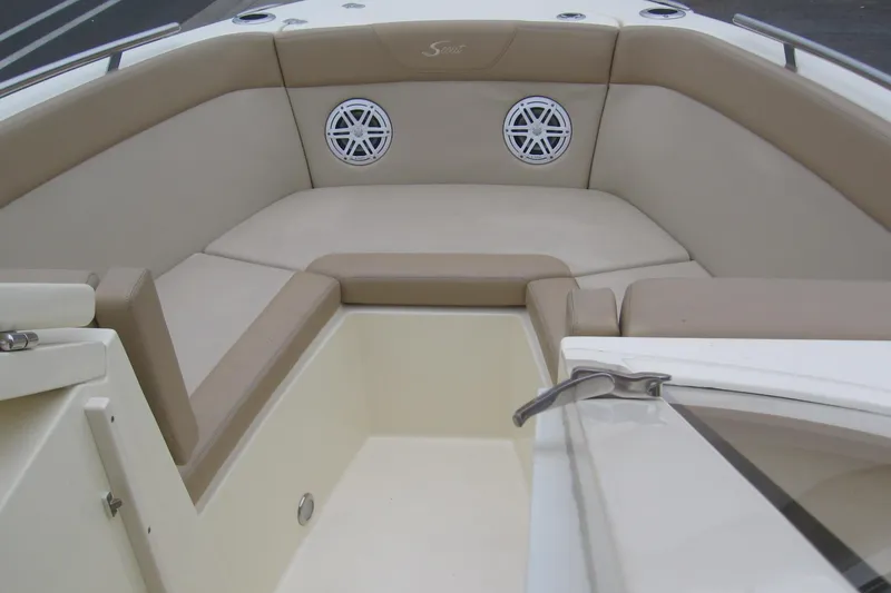 Slide: The Image of 2024 Scout 255 Dorado boat interior with beige seating and built-in speakers. - 5