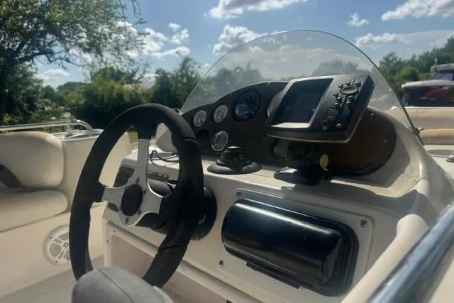 Slide: The Image of 1999 Hurricane SunDeck Sport 201 OB boat dashboard with steering wheel and gauges. - 11