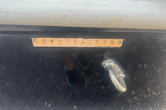 Slide: The Image of 1999 Hurricane SunDeck Sport 201 OB boat hull identification number with metal ring attachment. - 15