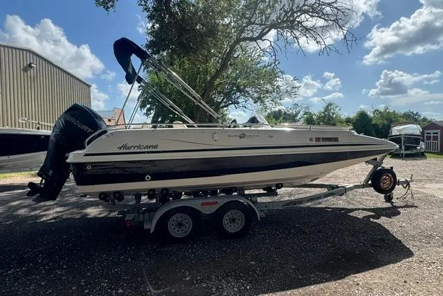 Slide: The Image of 1999 Hurricane SunDeck Sport 201 OB boat on trailer, parked outdoors under a clear sky. - 6