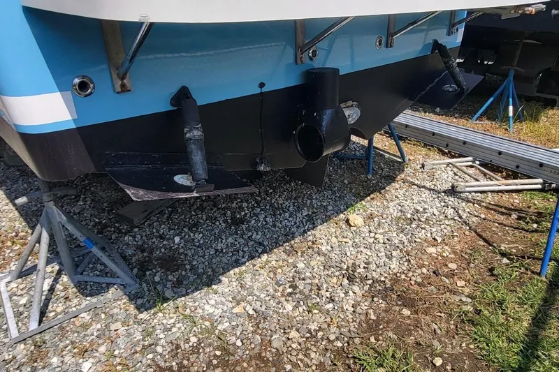 Slide: The Image of 2006 Back Cove 29 boat hull on stands, showing propeller and rudder. - 6