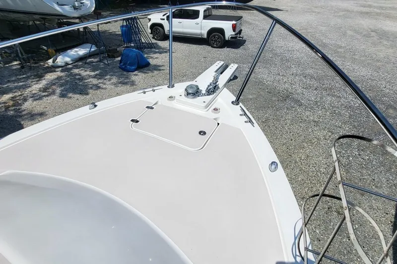 Slide: The Image of 2006 Back Cove 29 boat deck with anchor, parked on gravel near a white truck. - 10