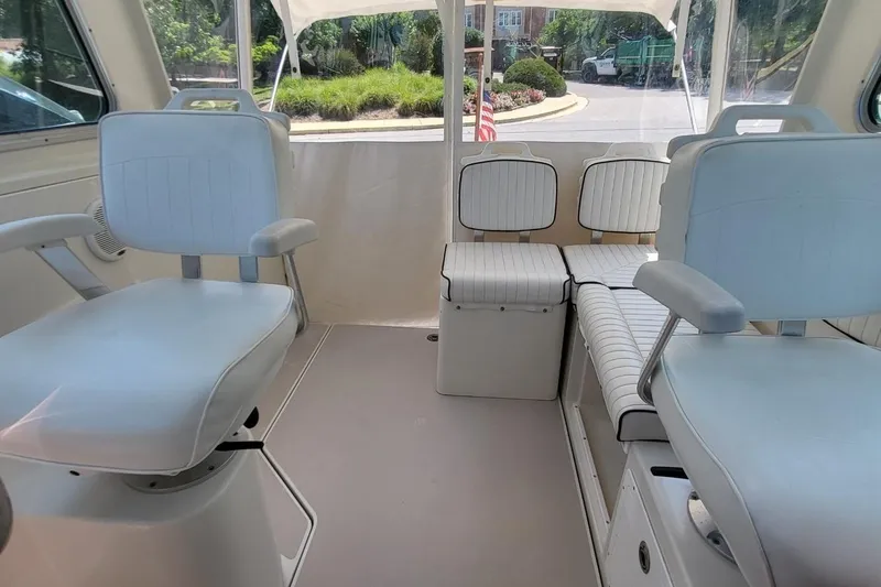 Slide: The Image of Interior of a 2006 Back Cove 29 boat with white seating and spacious layout. - 17