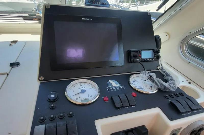 Slide: The Image of Control panel of a 2006 Back Cove 29 yacht with gauges and navigation equipment. - 16
