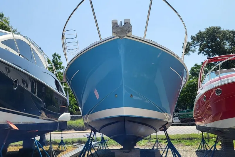 Slide: The Image of 2006 Back Cove 29 boat in dry dock, flanked by two other boats. - 3