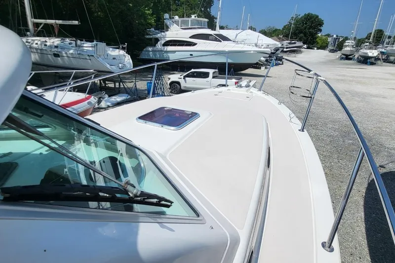 Slide: The Image of 2006 Back Cove 29 boat on dry dock, surrounded by other vessels and vehicles. - 14