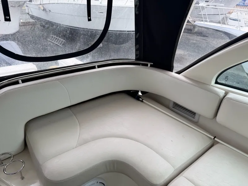 Slide: The Image of Interior of a 2009 Pursuit OS 3450 boat with beige upholstered seating. - 5