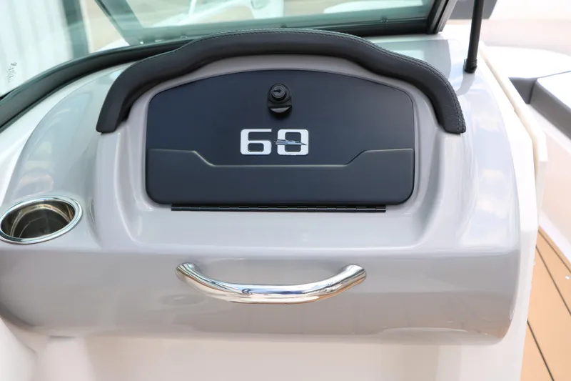 Slide: The Image of 2025 Chaparral 23 SSi boat dashboard with storage compartment and cup holder. - 49