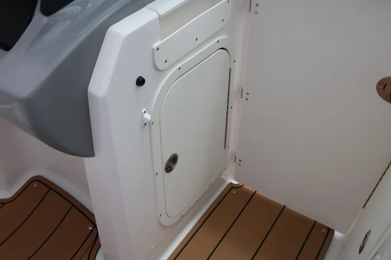 Slide: The Image of 2025 Chaparral 23 SSi boat interior with white hatch and brown flooring. - 38