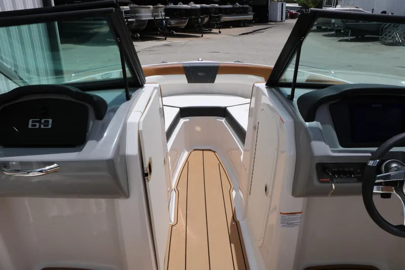 Slide: The Image of Interior view of 2025 Chaparral 23 SSi boat, featuring sleek dashboard and seating area. - 40