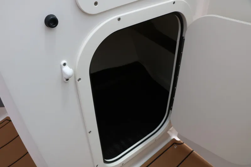 Slide: The Image of 2025 Chaparral 23 SSi boat storage compartment with open door. - 39
