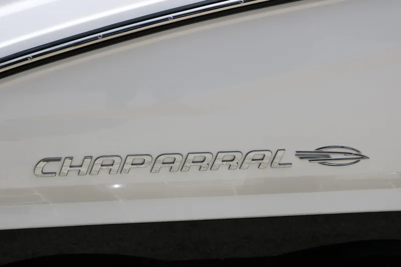 Slide: The Image of Chaparral 23 SSi 2025 boat logo on sleek white surface. - 13