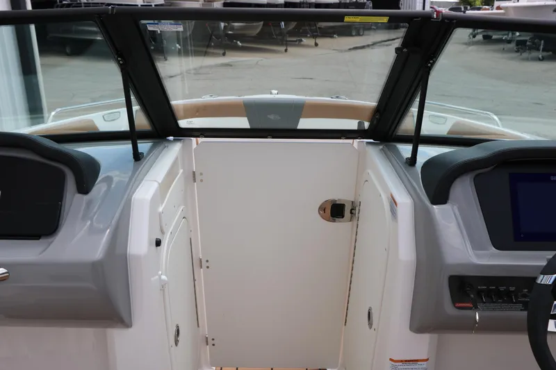 Slide: The Image of Interior view of 2025 Chaparral 23 SSi boat cockpit with windshield and control panel. - 37