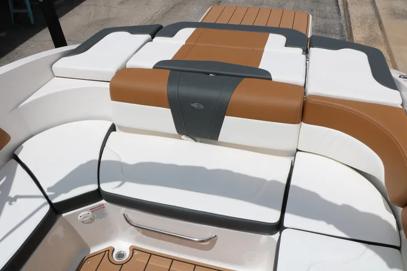 Slide: The Image of 2025 Chaparral 23 SSi boat interior with stylish brown and white seating. - 24