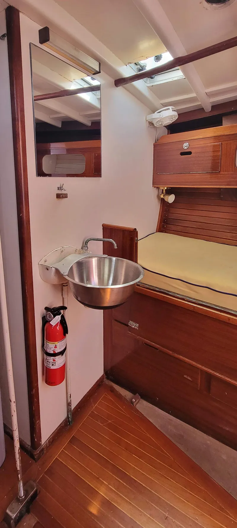 Slide: The Image of Interior of a yacht with a sink, mirror, and sleeping area. - 19
