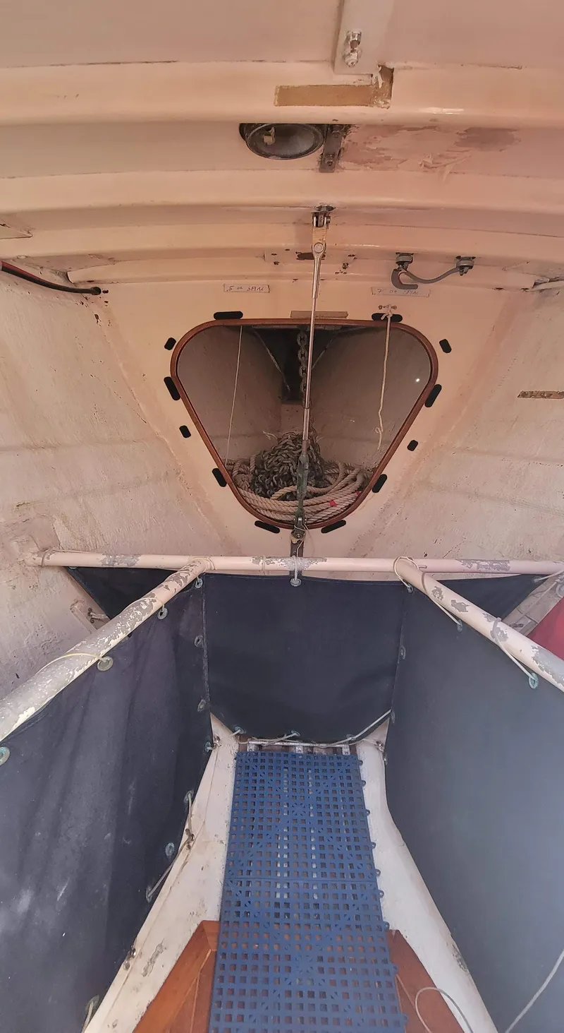 Slide: The Image of Interior view of a boat with a blue floor mat and an open storage area. - 22