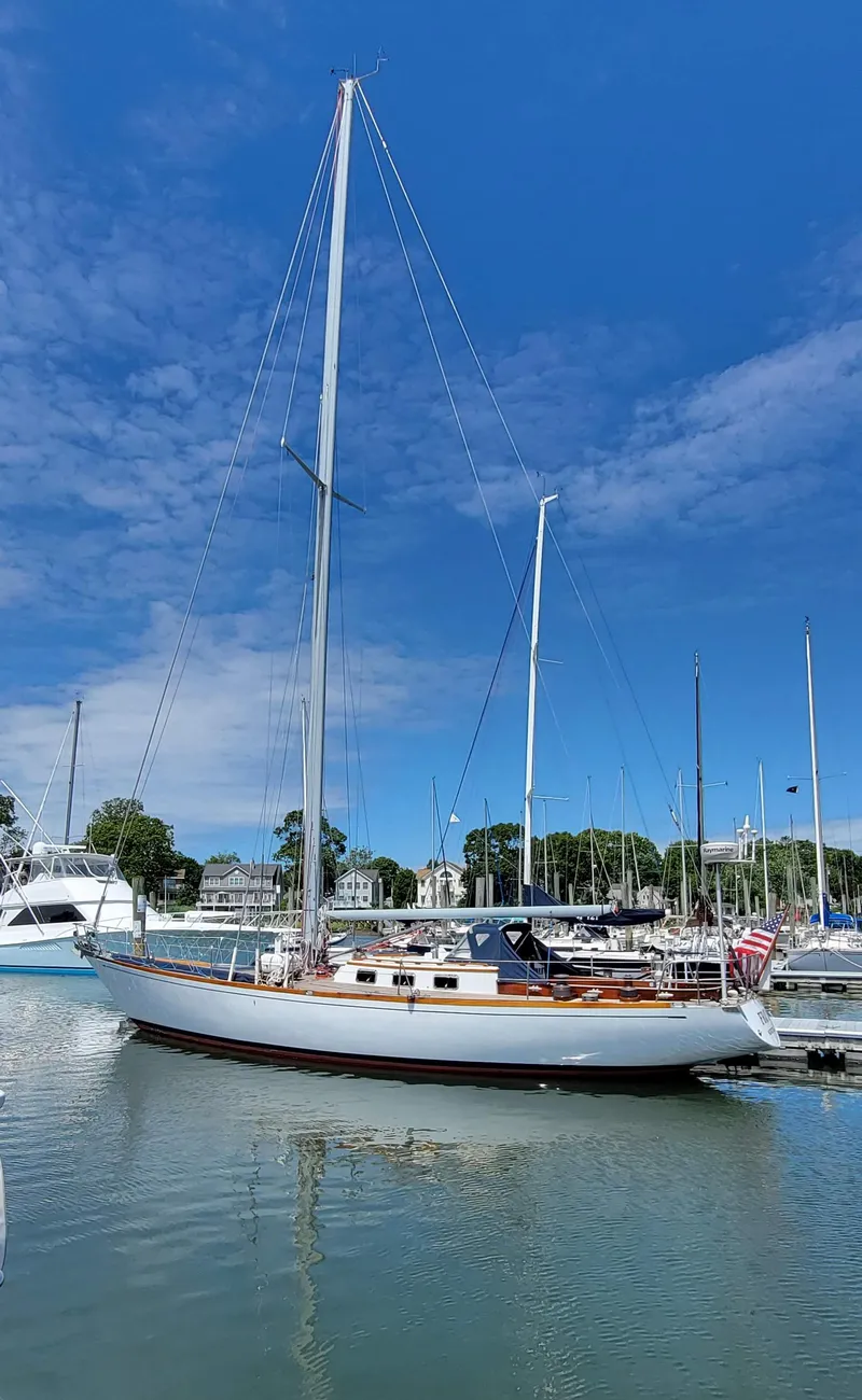 Slide: The Image of Sailboat docked in a marina under a blue sky. - 7