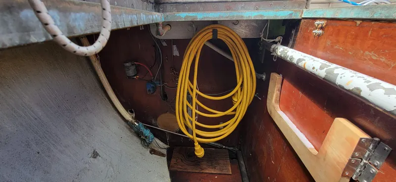Slide: The Image of A yellow cable hangs in a boat's interior with wooden walls and metal parts. - 29
