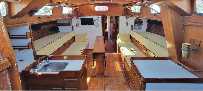 Slide: The Image of Interior of a classic sailboat with wooden fittings and beige cushions. - 12