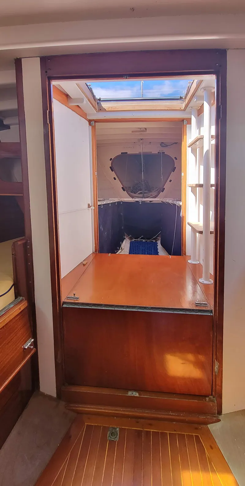 Slide: The Image of Interior of a yacht with wooden floors and a bed in the background. - 21