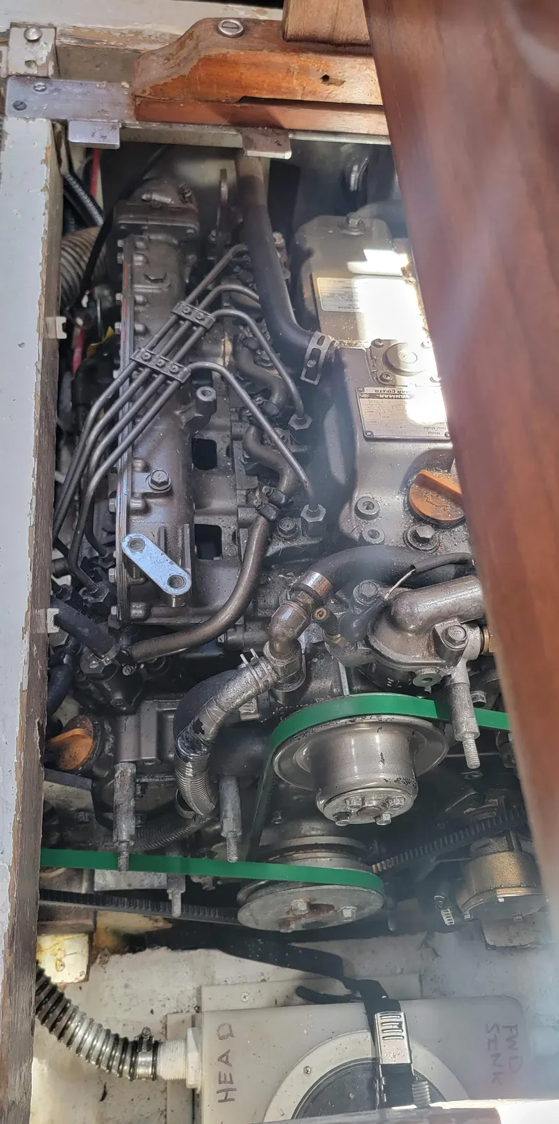 Slide: The Image of An engine compartment with a complex engine and various cables and hoses. - 30