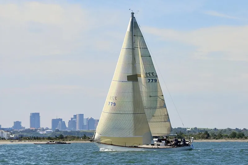 Slide: The Image of Vintage 1971 Frans Maas McCurdy & Rhodes 46 sailboat cruising near city skyline. - 5