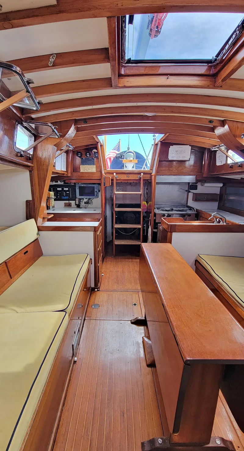 Slide: The Image of Interior view of a classic sailboat with wooden fittings and seating areas. - 14