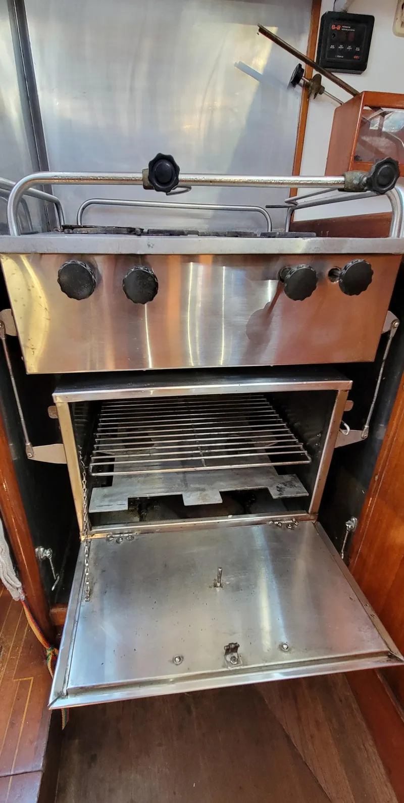 Slide: The Image of A stainless steel oven with an open door and four control knobs. - 25