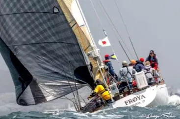 Slide: The Image of A sailboat with several people is sailing in strong wind. - 4